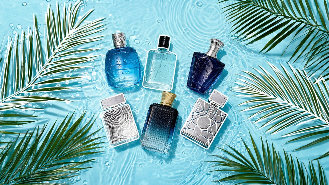 Five perfume bottles arranged on a water-covered light blue surface with ripples and droplets, framed by tropical palm leaves, creating a fresh, aquatic, summer-inspired fragrance display.