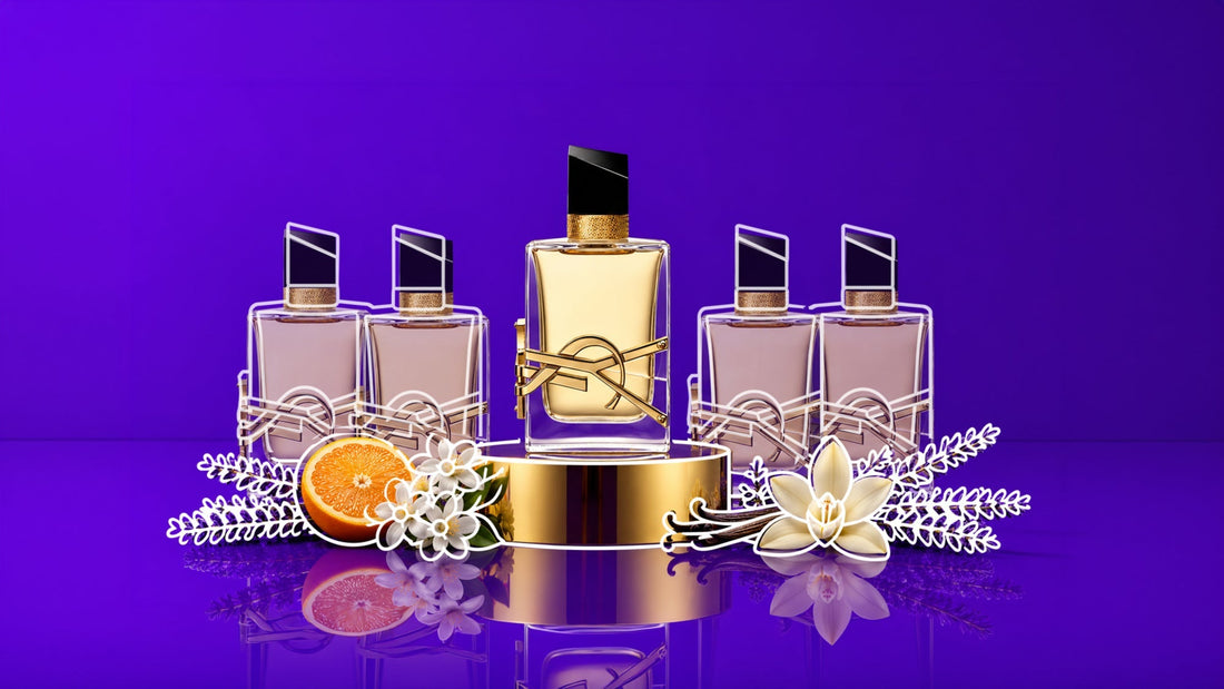 Five perfume bottles displayed on a reflective surface against a vibrant purple background, with the center bottle elevated on a gold pedestal and surrounded by orange, white blossoms, vanilla pods, and lavender sprigs.