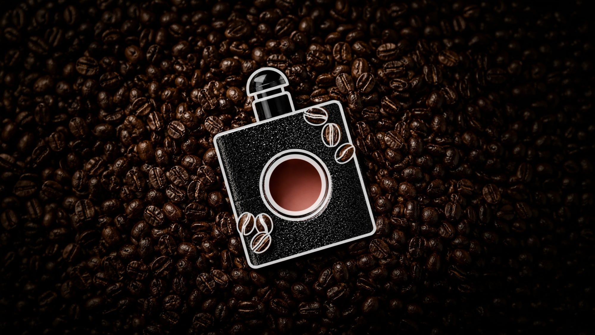 Black perfume bottle resting on a bed of roasted coffee beans, accented with white line-art coffee bean illustrations, highlighting rich coffee-inspired fragrance notes.