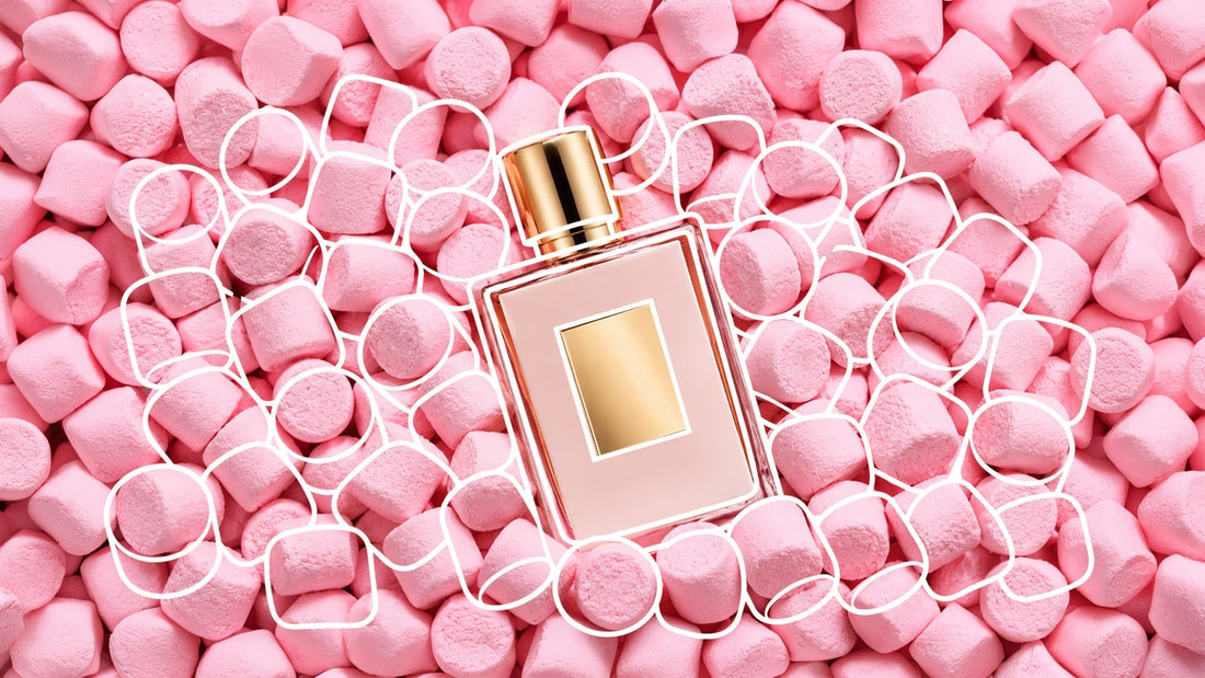 Perfume bottle with a gold cap and label resting on a bed of pink marshmallows, surrounded by white hand-drawn outlines highlighting the marshmallows in a playful, candy-inspired composition.